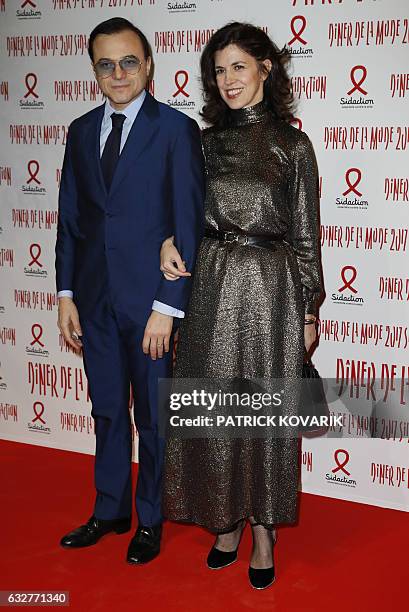 Music producer Bertrand Burgalat and fashion designer Vanessa Seward pose during a photocall upon arriving to attend the Diner de la Mode fundraiser...