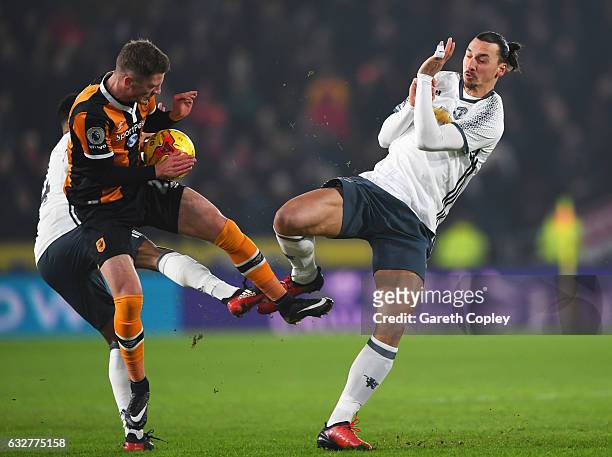 Josh Tymon of Hull City battles for the ball with Jesse Lingard and Zlatan Ibrahimovic of Manchester United during the EFL Cup Semi-Final second leg...