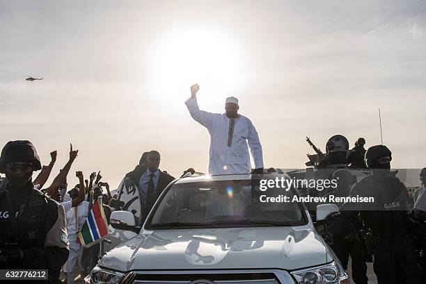 Gambian President Adama Barrow waves to supporters as he leaves Banjul International Airport on January 26, 2017 in Banjul, The Gambia. Barrow had...