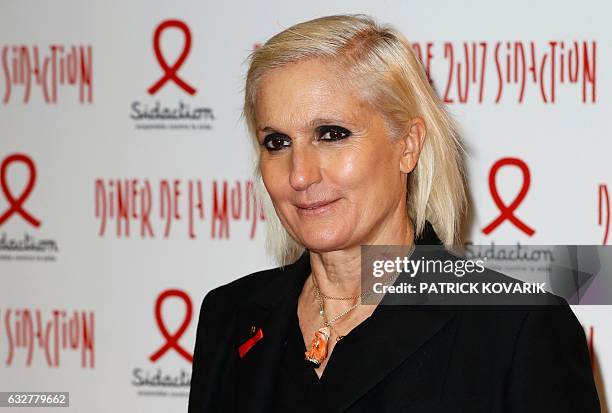 Italian fashion designer Maria Grazia Chiuri poses during a photocall upon arriving to attend the Diner de la Mode fundraiser dinner in profit of...