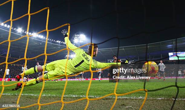 Tom Huddlestone of Hull City scores their first goal from the penalty spot past goakeeper David De Gea of Manchester United during the EFL Cup...