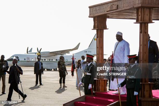 Gambia's new president Adama Barrow arrives at Banjul airport on January 26, 2017 in Banjul, after returning from Senegal. Jubilant Gambians on...