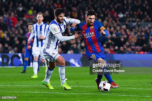 Lionel Messi of FC Barcelona competes for the ball with Raul Navas of Real Sociedad de Futbol during the Copa del Rey quarter-final second leg match...