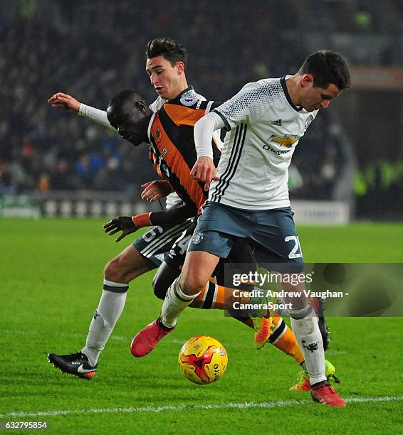 Hull City's Oumar Niasse gets between Manchester United's Ander Herrera, right, and Matteo Darmian during the EFL Cup Semi-Final Second Leg match...