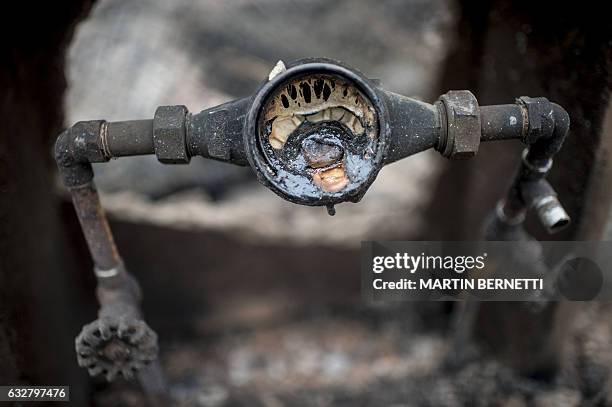 Debris seen in the town of Santa Olga, which was destroyed by a forest fire, 330 km south of Santiago, on January 26, 2017. Six people -- among them...