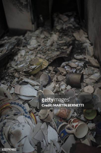 Debris seen in the town of Santa Olga, which was destroyed by a forest fire, 330 km south of Santiago, on January 26, 2017. Six people -- among them...