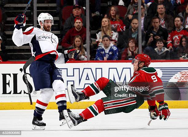 Brooks Orpik of the Washington Capitals hits Taylor Hall of the New Jersey Devils in the third period on January 26, 2017 at Prudential Center in...