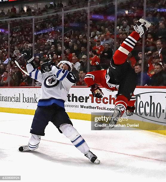 Marian Hossa of the Chicago Blackhawks flips through the air after colliding with Josh Morrissey of the Winnipeg Jets at the United Center on January...