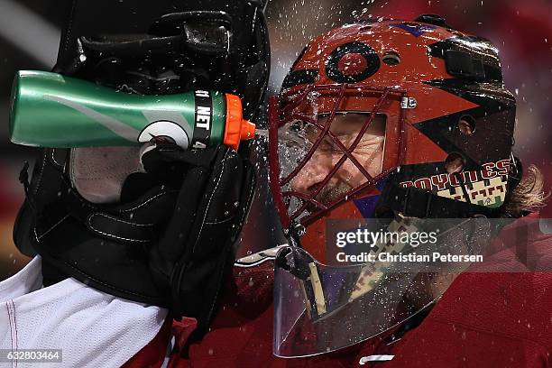 Goaltender Mike Smith of the Arizona Coyotes sprays water in his face during a break from the second period of the NHL game against the Vancouver...