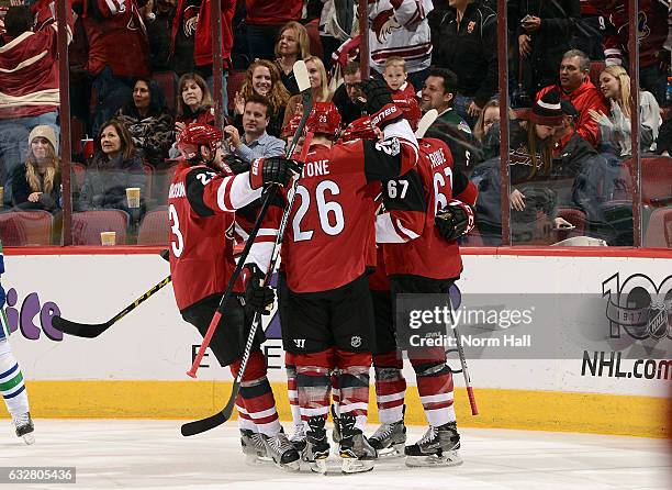 Lawson Crouse of the Arizona Coyotes celebrates with Oliver Ekman-Larsson, Michael Stone and teammates after scoring a second period goal against the...