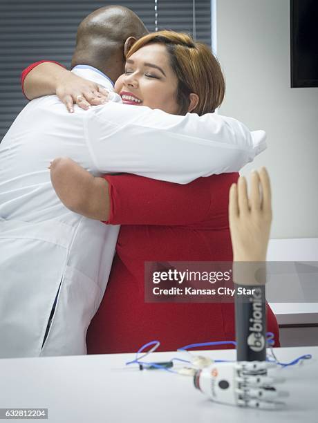 Gaby Carmona, right, hugs Julian Wells, certified prosthetists, after being told that she is the recipient of not one, but two bionic prosthetic...