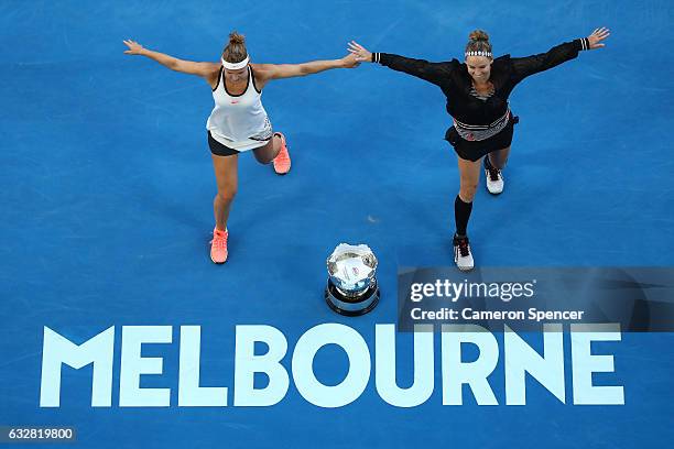 Bethanie Mattek-Sands of the United States and Lucie Safarova of the Czech Republic perform a dance around the championship trophy after winning...