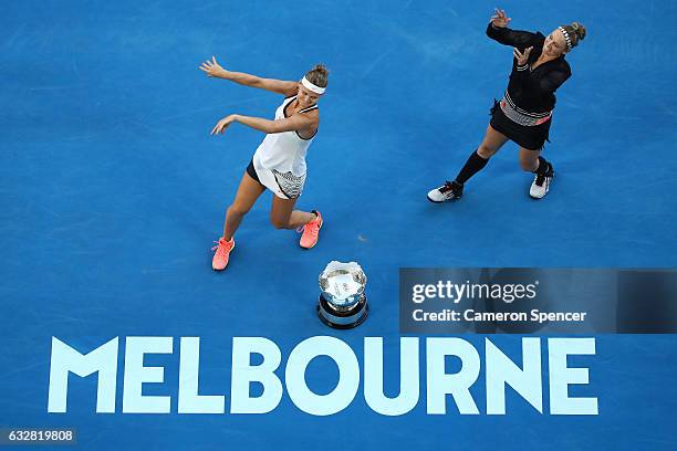 Bethanie Mattek-Sands of the United States and Lucie Safarova of the Czech Republic perform a dance around the championship trophy after winning...