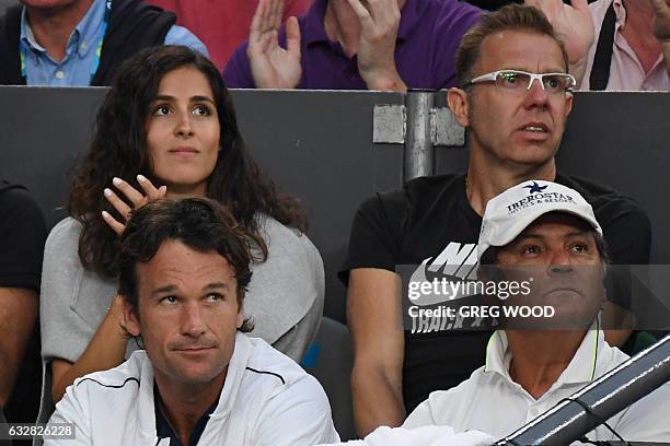 Xisca Perello and Toni Nadal , the respective girlfriend and coach of Spain's Rafael Nadal, watch him play against Bulgaria's Grigor Dimitrov during...