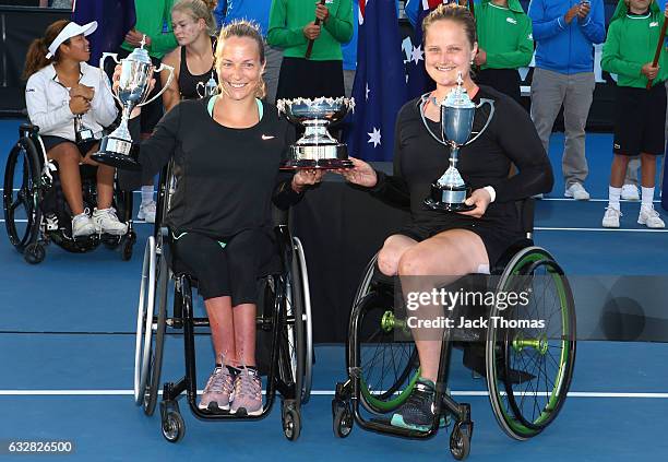 Jiske Griffioen and Aniek Van Koot of the Netherlands pose with the winners trophy after their doubles final match against Diede De Groot of the...