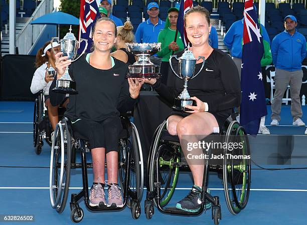 Jiske Griffioen and Aniek Van Koot of the Netherlands pose with the winners trophy after their doubles final match against Diede De Groot of the...