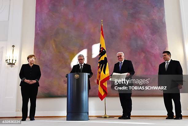 German Chancellor Angela Merkel , German President Joachim Gauck and designated German Foreign minister Sigmar Gabriel look on as outgoing German...