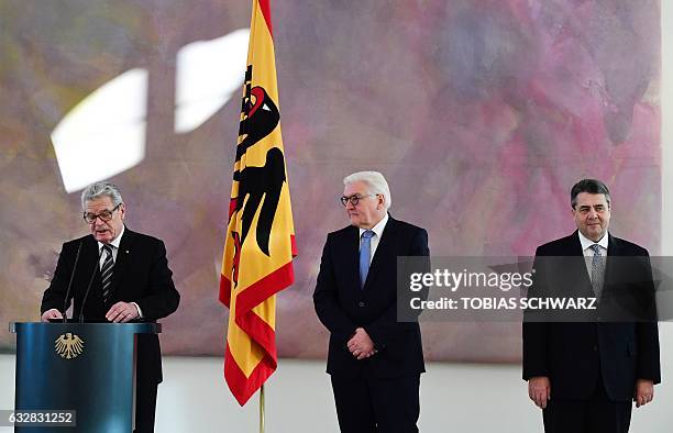 German President Joachim Gauck speaks as outgoing German Foreign Minister Frank-Walter Steinmeier and his successor and former German Economy and...