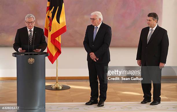 German President Joachim Gauck speaks as outgoing Foreign Minister Frank-Walter Steinmeier and new Foreign Minister Sigmar Gabriel look on during a...