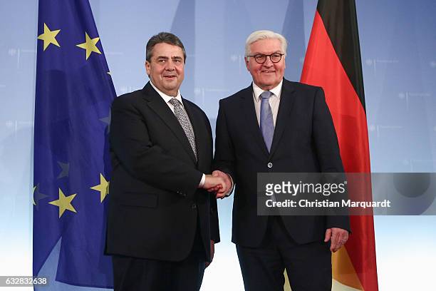 German Foreign Minister Frank-Walter Steinmeier hands over his office to his successor Sigmar Gabriel at the Ministry of Foreign Affairs on January...