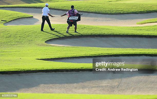 Gary Stal of France and his caddie walk upp the seventh hole during the second round of the Commercial Bank Qatar Masters at the Doha Golf Club on...