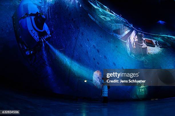 Woman takes a picture of a large-scale 360 degree panorama presentation of the Titanic shipwreck by artist Yadegar Asisi during a press preview on...
