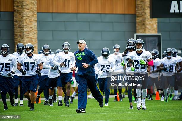 Seattle Seahawks assistant head coach and defensive line coach Dan Quinn taking field with players during training camp at Virginia Mason Athletic...