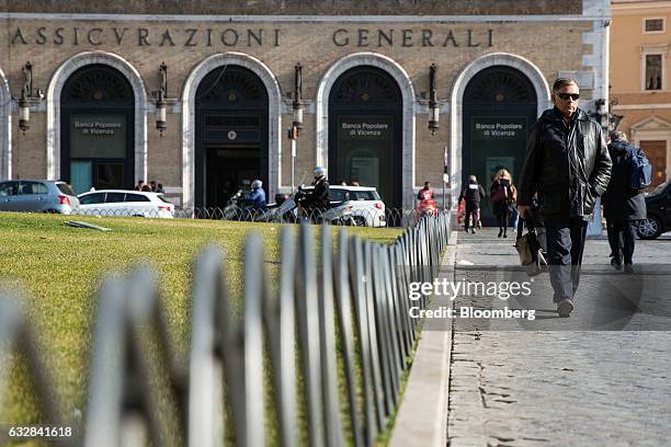 Pedestrians walk near to the Assicurazioni Generali SpA headquarters in Rome, Italy, on Friday, Jan. 27, 2017. Intesa Sanpaolo SpA Chief Executive...