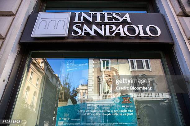 An Intesa Sanpaolo SpA logo sits on the side of one of their bank branches in Rome, Italy, on Friday, Jan. 27, 2017. Intesa Chief Executive Officer...