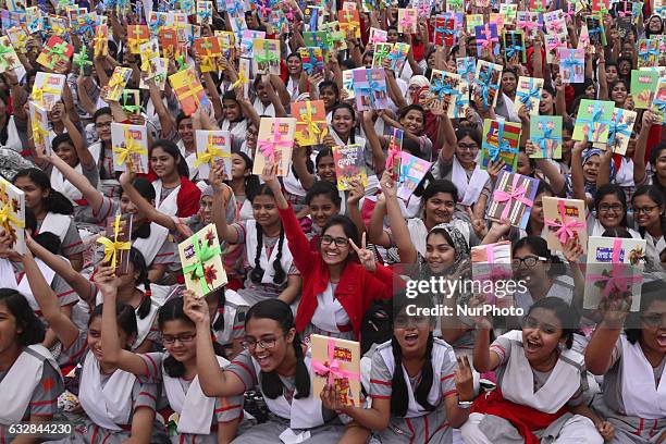 Bangladeshi School's Student raise up their hands with Books in the program Winners of a book-reading competition organized by Bishwo Shahitto Kendro...