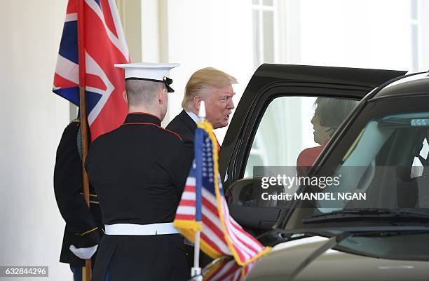 President Donald Trump greets Britain's Prime Minister Theresa May as she arrives for meetings outside of the West Wing of the White House on January...