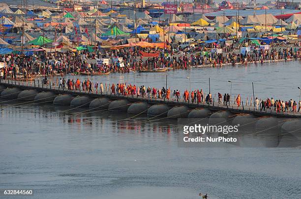 Indian hindu devotees move on temporary pantoon tank bridge as they return after taking a holy dip at sangam ,confluence of three rivers ,ganges ,...
