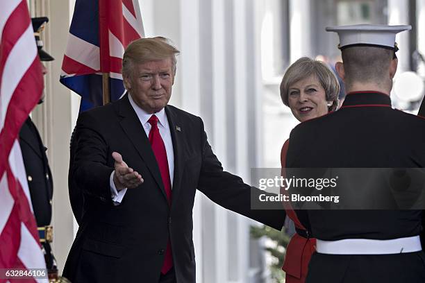 President Donald Trump, left, welcomes Theresa May, U.K. Prime minister, while arriving to the West Wing of the White House in Washington, D.C.,...