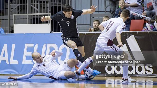 Konstantins Zabraovskis of Latvia challenges Marc Philipp Nebgen of Germany during the UEFA Futsal European Championship Qualifying match between...