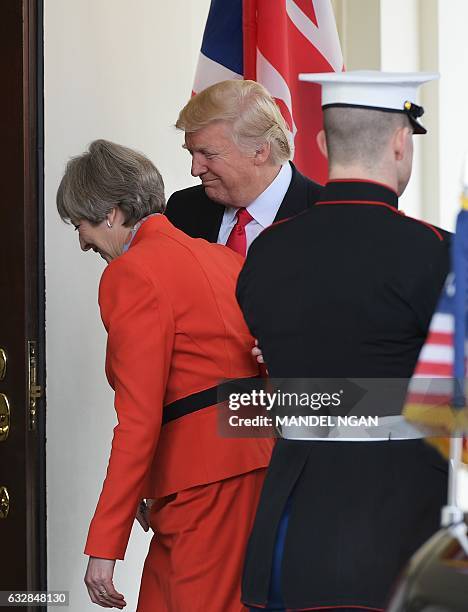 President Donald Trump greets Britain's Prime Minister Theresa May as she arrives for meetings outside of the West Wing of the White House on January...