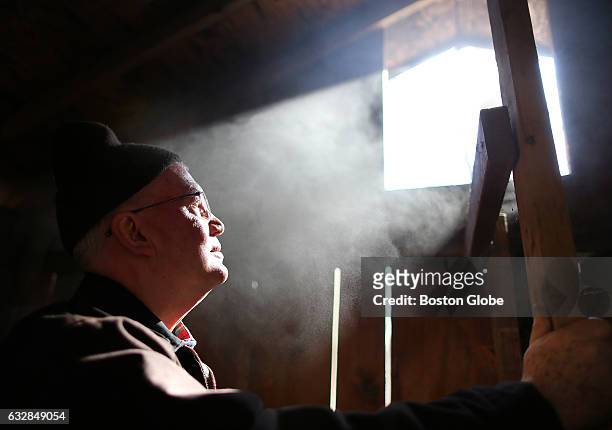 Volunteer David Rice watches the steam escape from the sugar shack where maple sugaring takes place at the Moose Hill Wildlife Sanctuary in Sharon,...
