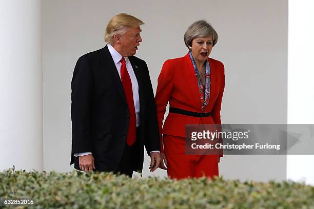 British Prime Minister Theresa May with U.S. President Donald Trump walk along The Colonnade at The White House on January 27, 2017 in Washington,...