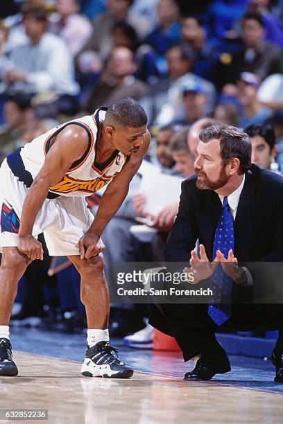 Golden State Warriors head coach PJ Carlesimo talks with Muggsy Bogues during a game played on November 25, 1997 at the Arena in Oakland in Oakland,...