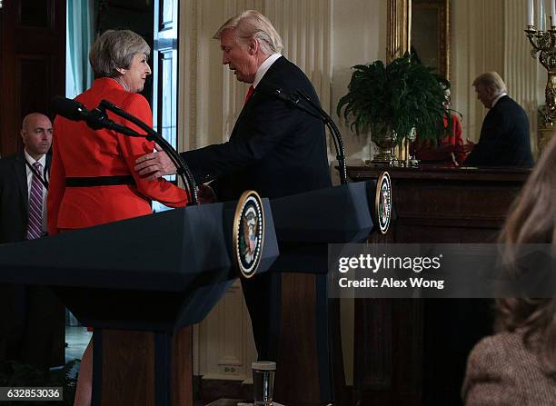 President Donald Trump shakes hands with British Prime Minister Theresa May after a joint press conference in the East Room of the White House...