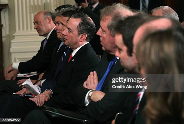 White House Chief of Staff Reince Priebus listens as U.S. President Donald Trump and British Prime Minister Theresa May participate in a joint press...