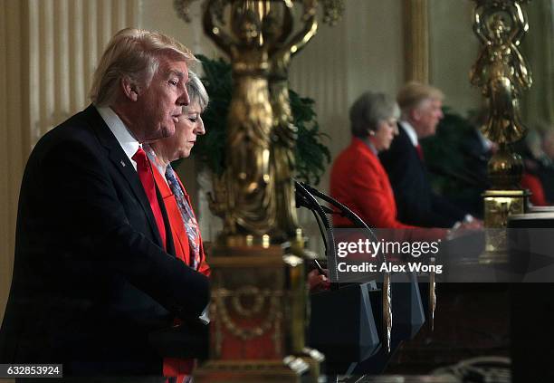 As their images are reflected on a mirror, U.S. President Donald Trump and British Prime Minister Theresa May participate in a joint press conference...