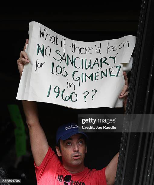 Derek Merleaux joins with other protesters against Miami-Dade Mayor Carlos Gimenez's decision to abide by President Donald Trump's order, that any...