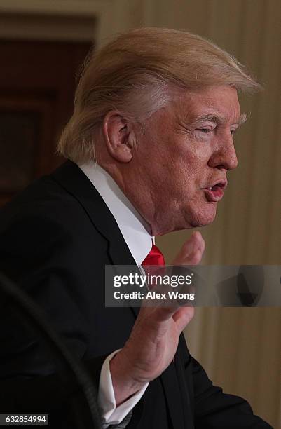 President Donald Trump participates in a joint press conference with British Prime Minister Theresa May in the East Room of the White House January...