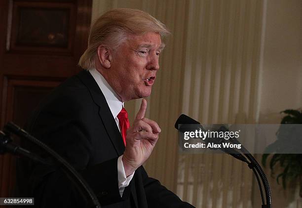 President Donald Trump participates in a joint press conference with British Prime Minister Theresa May in the East Room of the White House January...