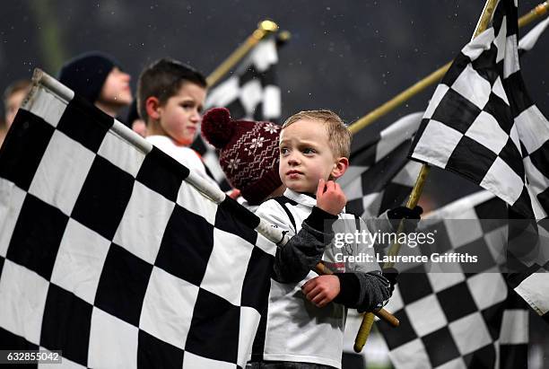 Young Derby supporters holds a flag prior to The Emirates FA Cup Fourth Round match between Derby County and Leicester City at iPro Stadium on...