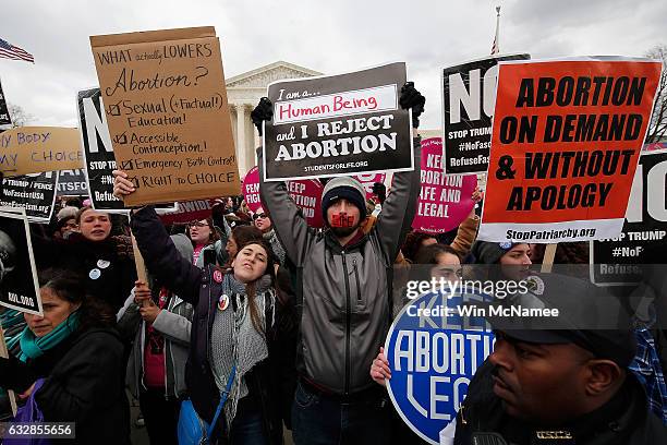 Mix of anti-abortion advocates and pro-choice advocates rally outside of the Supreme Court during the March for Life, January 27, 2017 in Washington,...