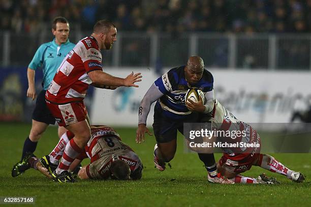 Beno Obano of Bath is tackled by Callum Braley of Gloucester as Yann Thomas closes in during the Anglo Welsh Cup match between Bath Rugby and...