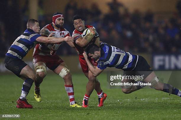 Motu Matu'u of Gloucester is tackled by Elliott Stooke of Bath as Chris Cook supports during the Anglo Welsh Cup match between Bath Rugby and...