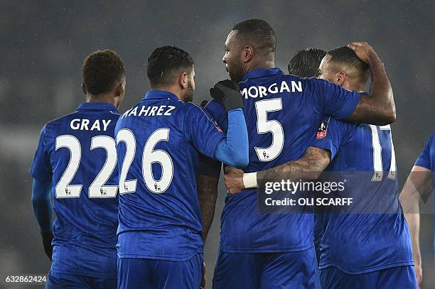 Leicester City's English-born Jamaican defender Wes Morgan celebrates with Leicester City's English midfielder Demarai Gray , Leicester City's...