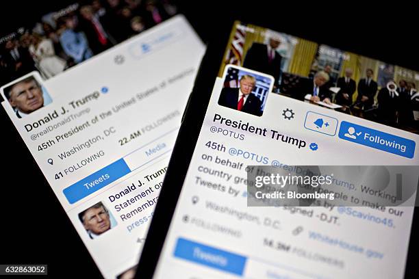 The Twitter Inc. Accounts of U.S. President Donald Trump, @POTUS and @realDoanldTrump, are seen on an Apple Inc. IPhone arranged for a photograph in...